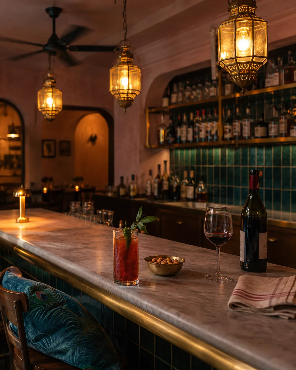 The bar at Chai St Indian Bistro at dusk, brass lanterns over a marble counter.
